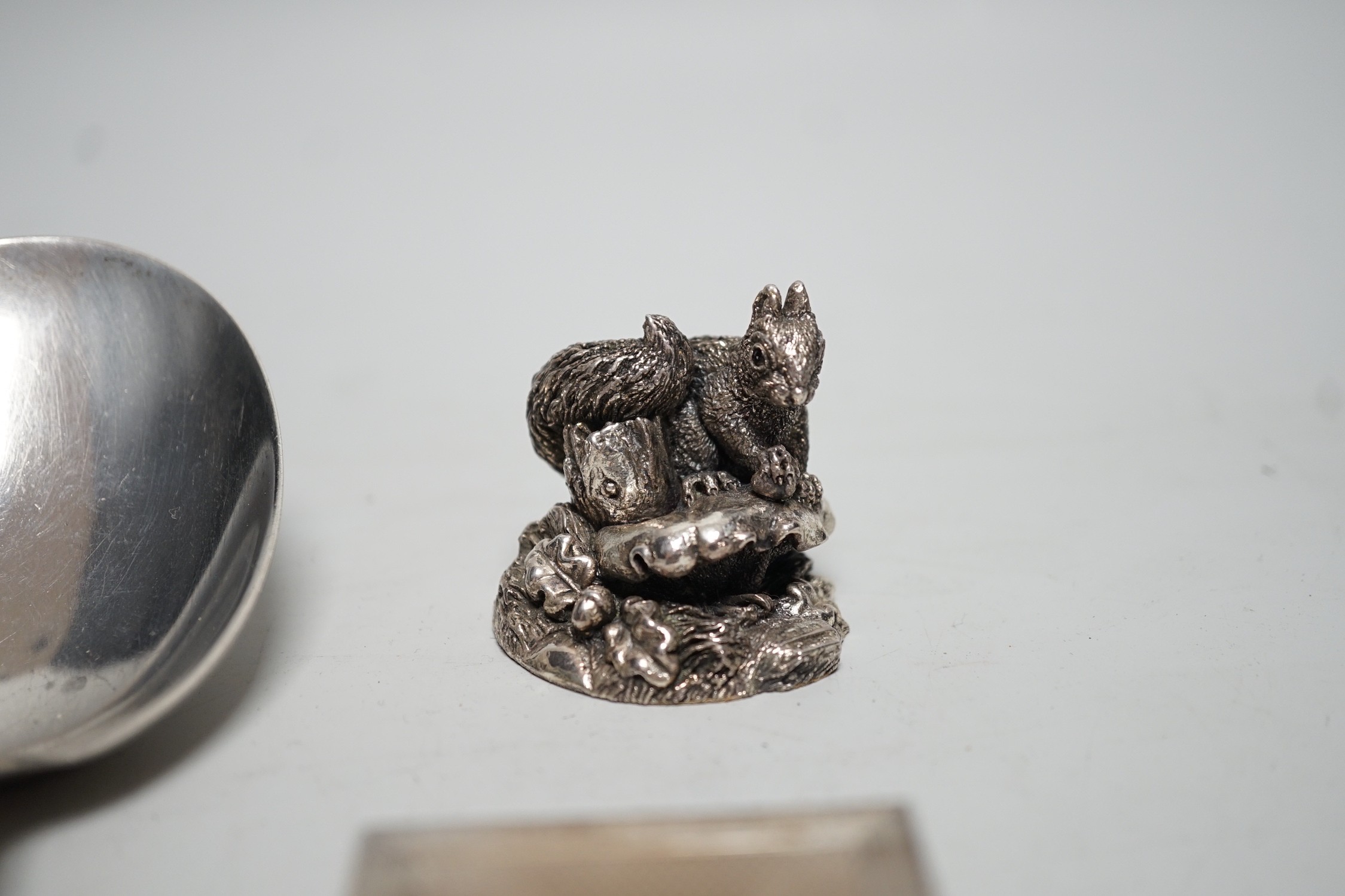 A pair of George V sterling silver salad servers, Birmingham import marks, 22cm, a modern silver pill box and match sleeve and a modern silver (filled) model squirrel.